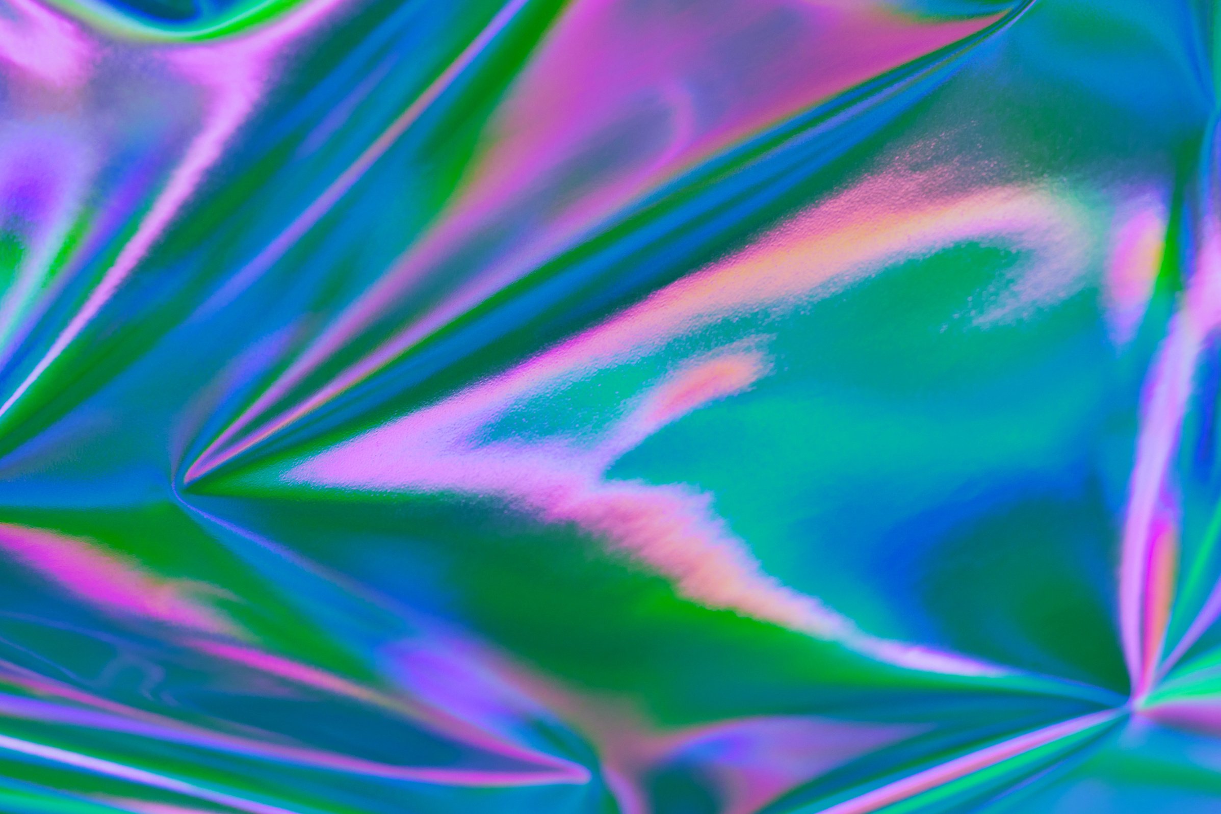 Abstract neon holographic metallic foil background in 80s, 90s style